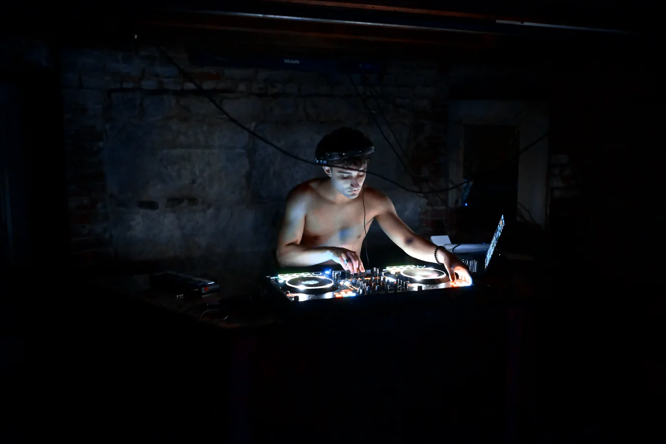 Diffusion playing to a basement room, lit only by the controller