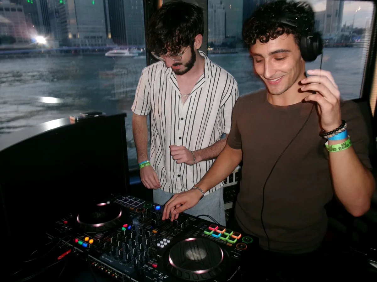 Playing a back-to-back set on a boat, the Manhattan skyline behind the booth