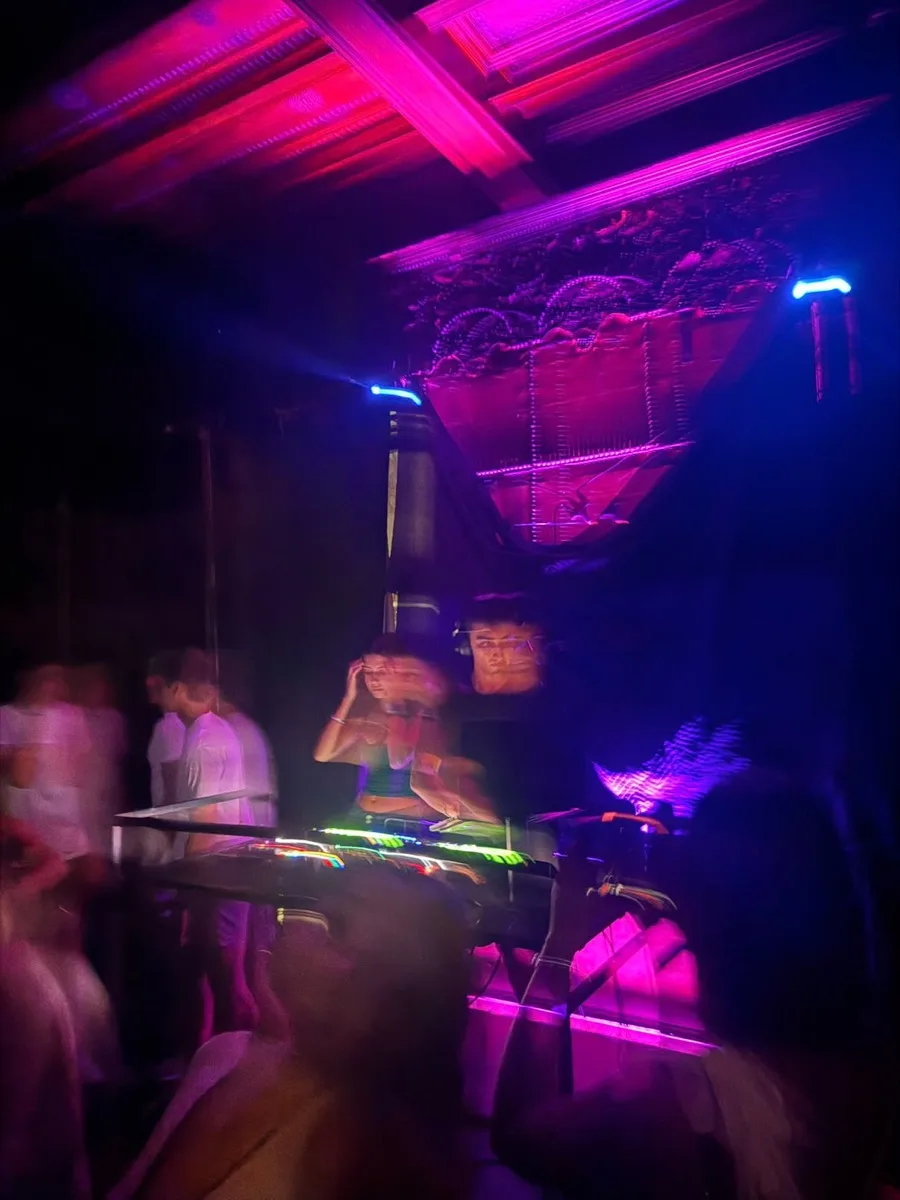 Long-exposure shot of Diffusion mid-set under pink and blue club lighting